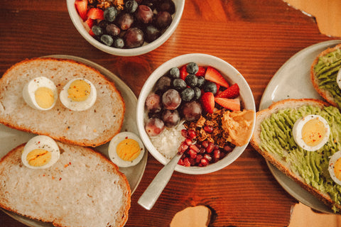 Balanced breakfast with eggs yogurt fruit and toast as protein-rich foods