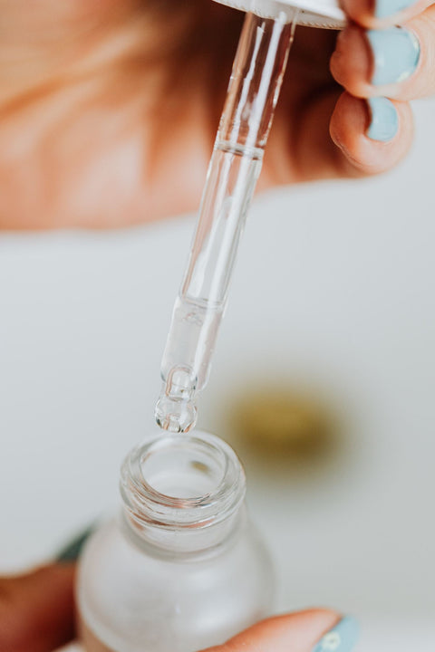 Serum dropper above an unbranded bottle. Photo: kaboompics via Pexels.