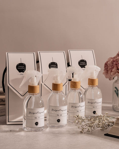 Collection of fragrance bottles and shopping bags. Photo: Ali Dashti via Pexels.