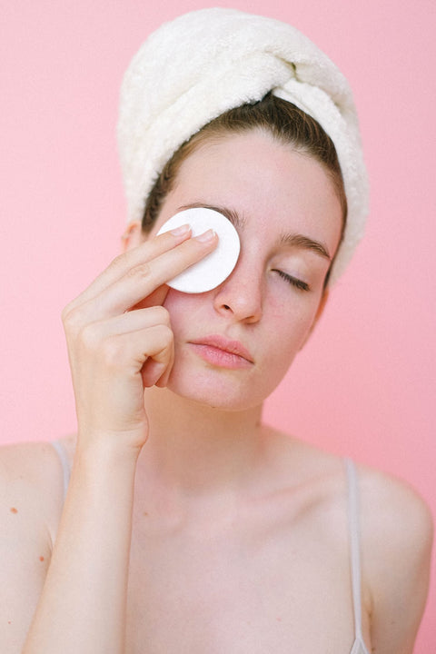 Woman gently removing eye makeup with a cotton pad. Photo: Anna Shvets via Pexels.