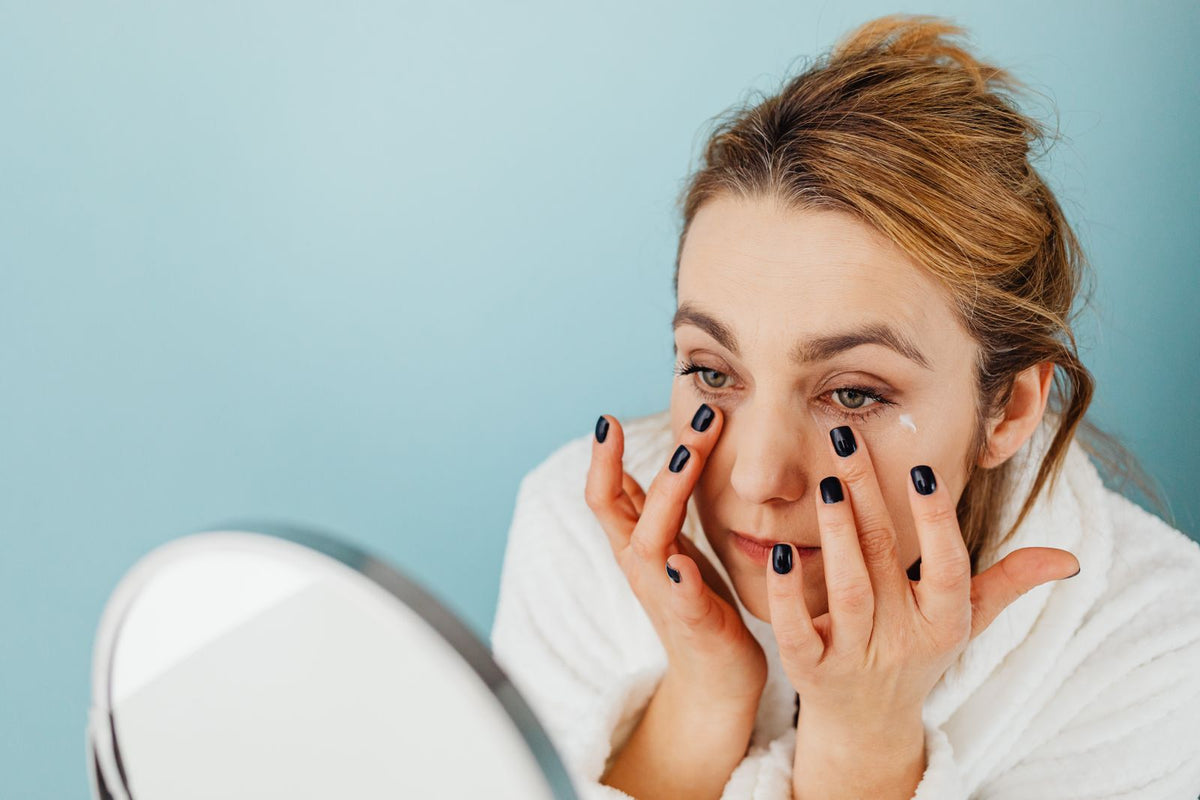 Woman applying eye cream under the eyes during her skincare routine