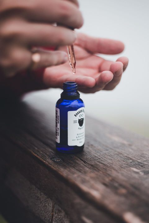 Glass dropper and blue serum bottle. Photo: Erik Mclean via Pexels.
