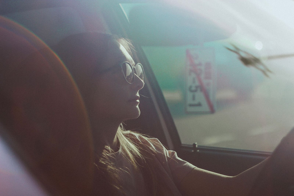 Woman driving beside a sunlit car window, Alexander Taranenko via Pexels