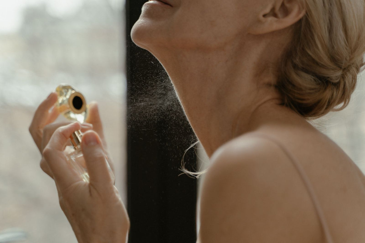 Woman applying fragrance with glass bottle, Ron Lach via Pexels