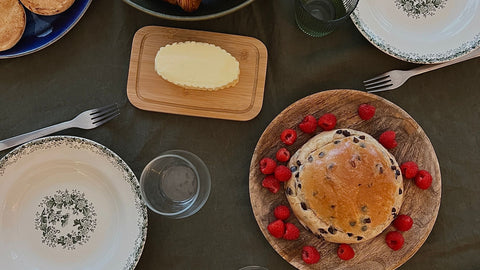 Overhead breakfast table with croissants, berries and other foods, illustrating a balanced discussion of sugar and acne. Photo via Pexels.