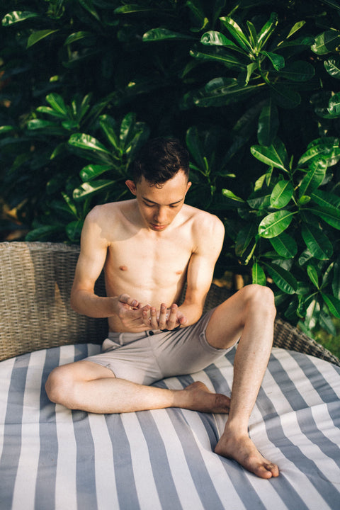 Man applying sunscreen outdoors in bright sunlight